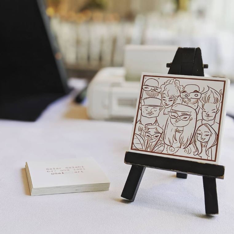 Guest holding their finished caricature